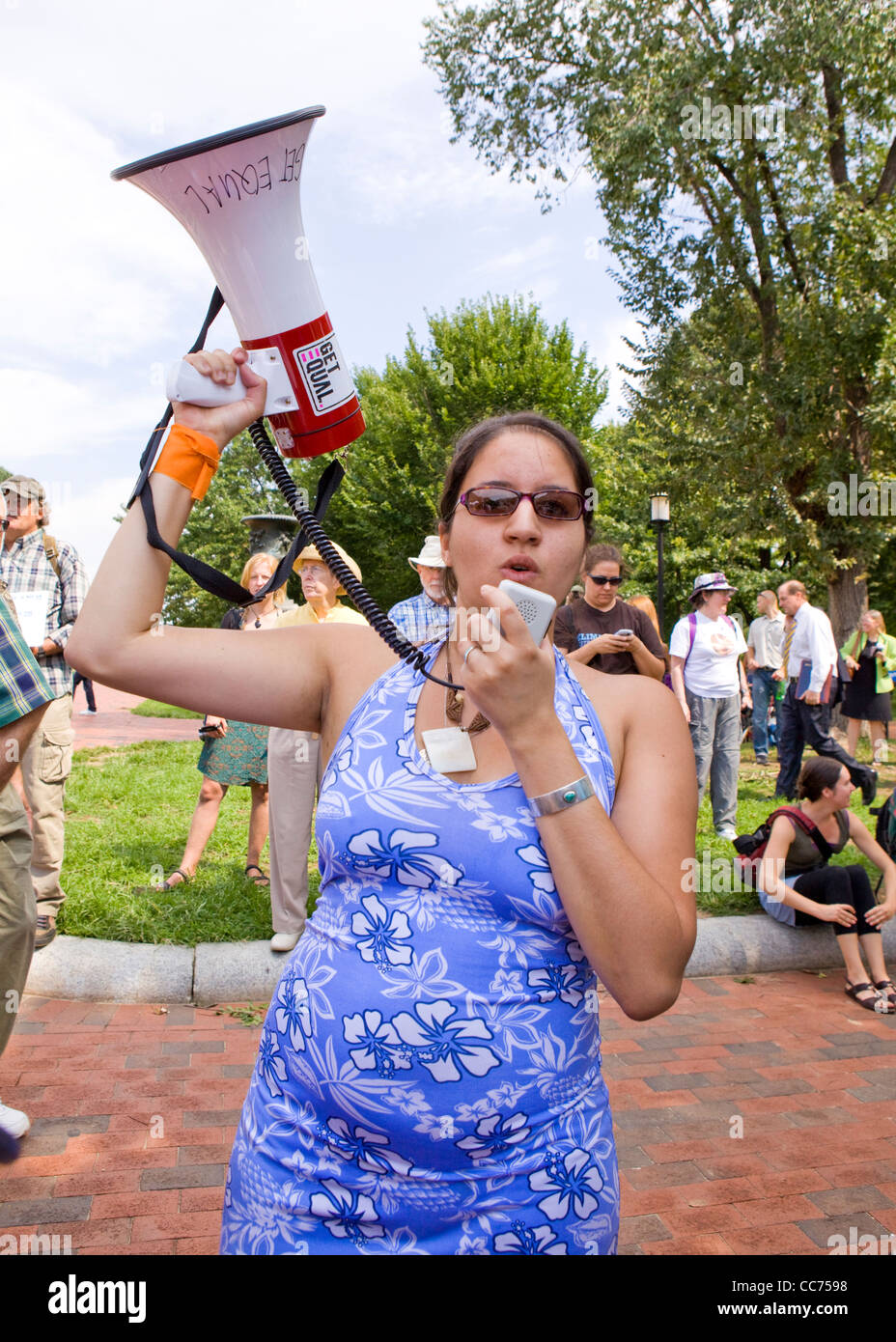 Female protester speaking through a bullhorn Stock Photo