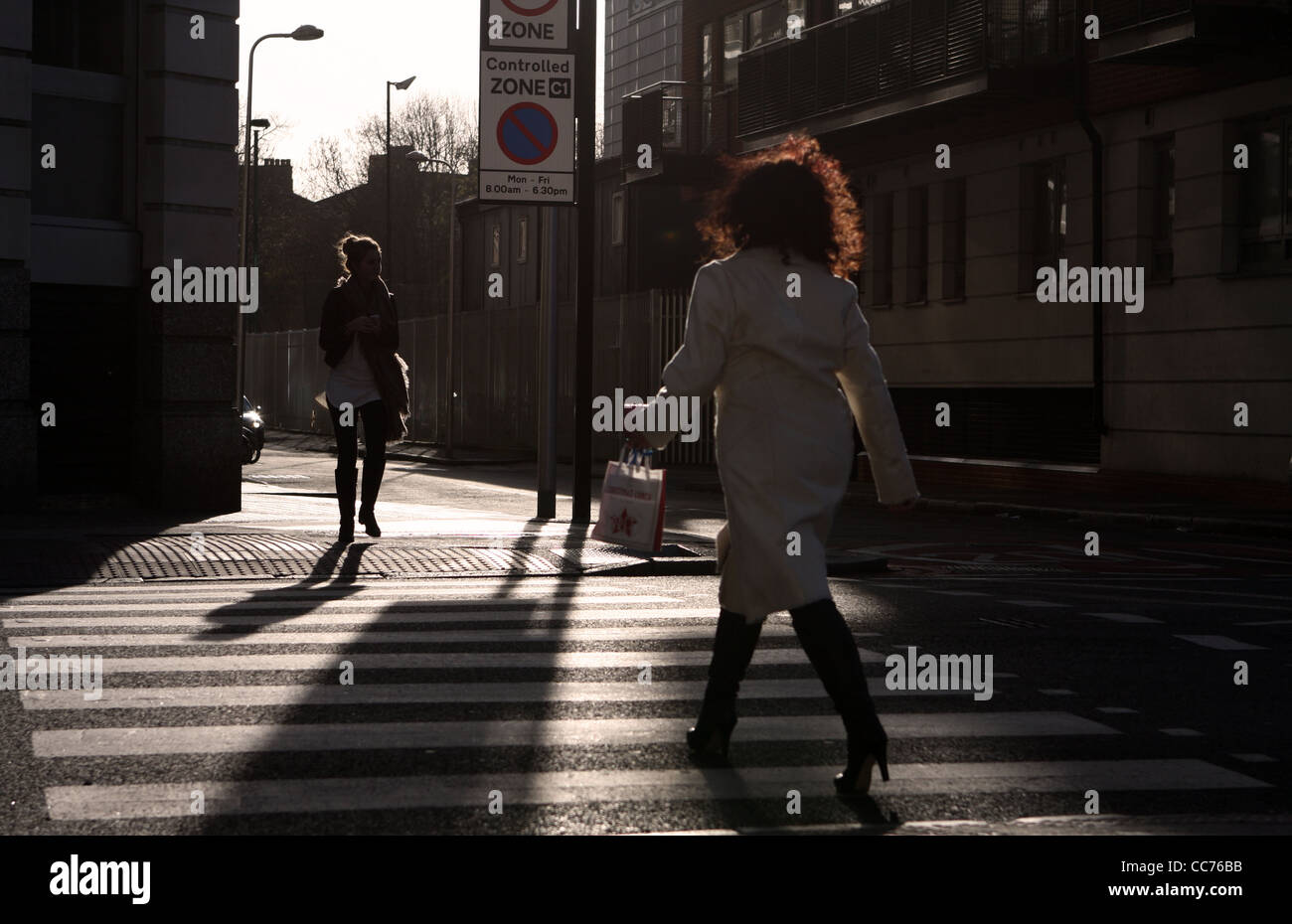two females crossing a zebra crossing in London Stock Photo