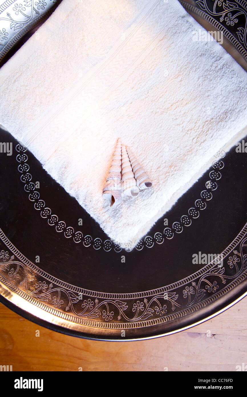 Luxury towel in silver scale on wooden table Stock Photo
