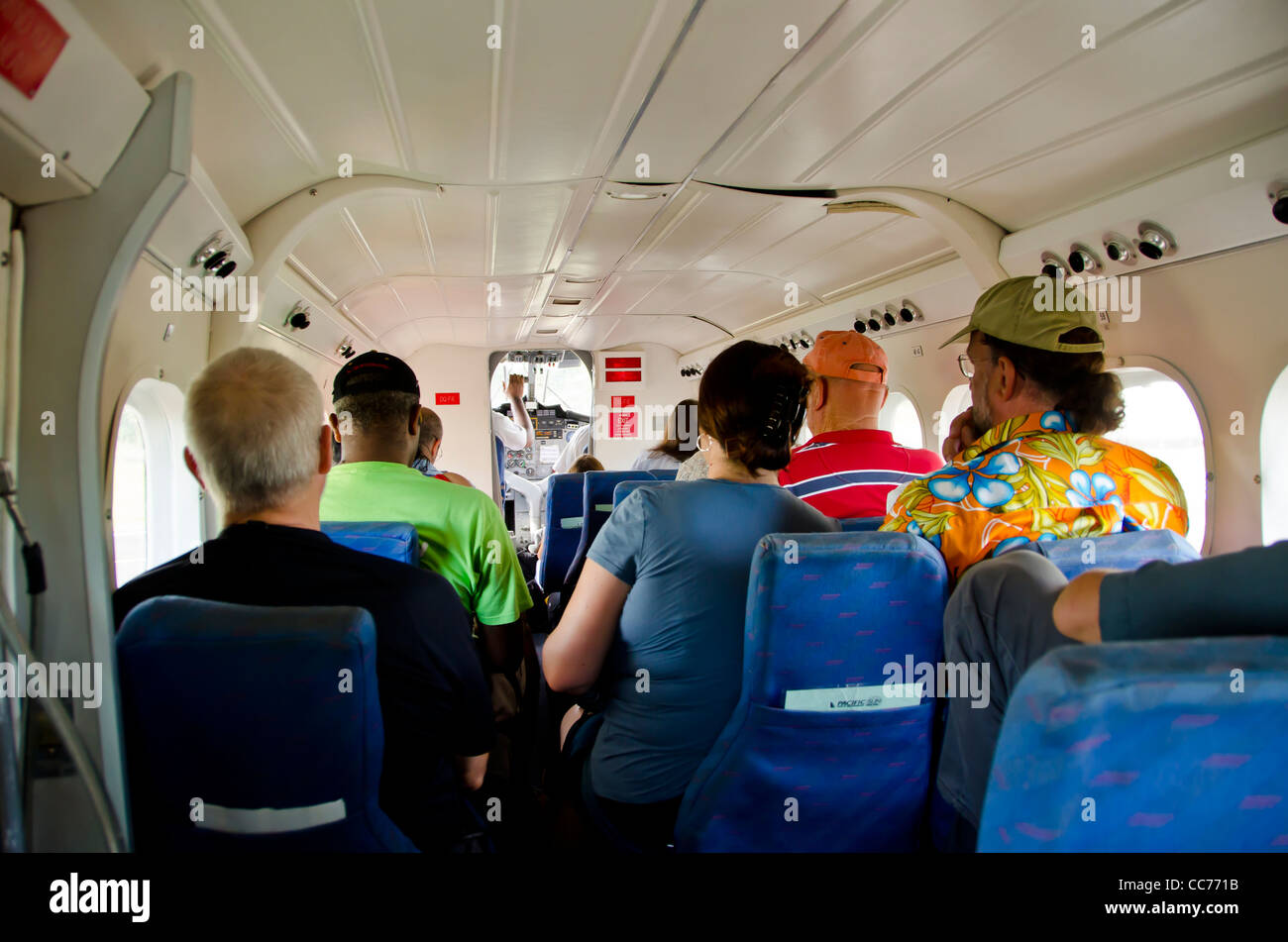 Fiji Sun Air small prop airplane interior with cramped space and passengers Stock Photo