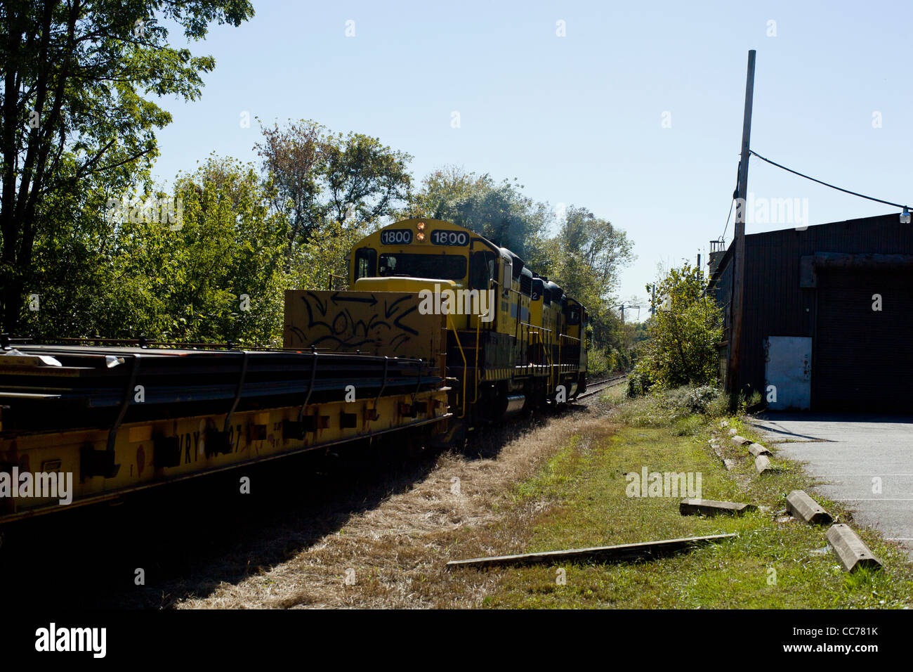 Train yellow motion warehouse sunny day Stock Photo