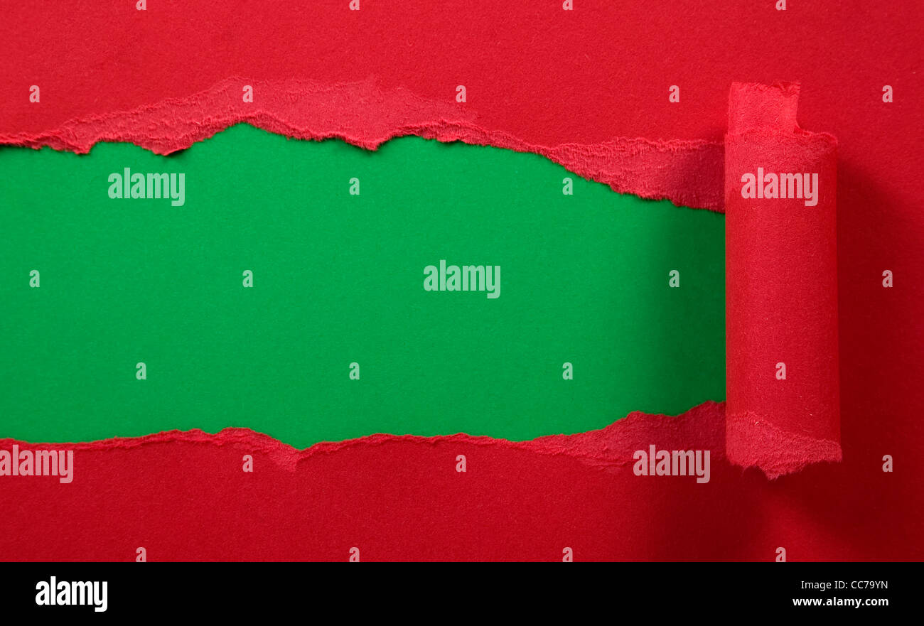 Ripped red paper with green background, frame composition Stock Photo