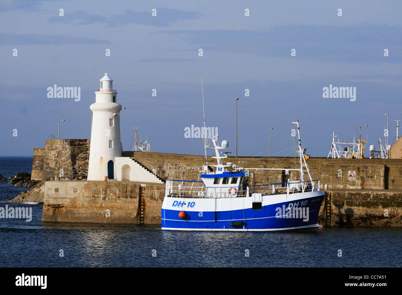 fishing boat entering macduff harbour Stock Photo - Alamy