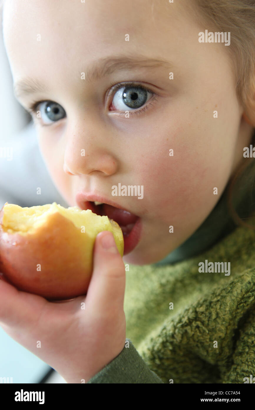 Little girl eating apple Stock Photo Alamy