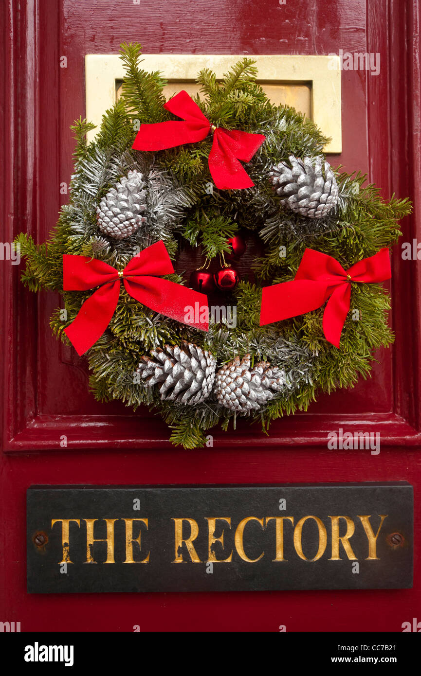 a traditional Christmas wreath on the door of The Rectory house home UK Stock Photo