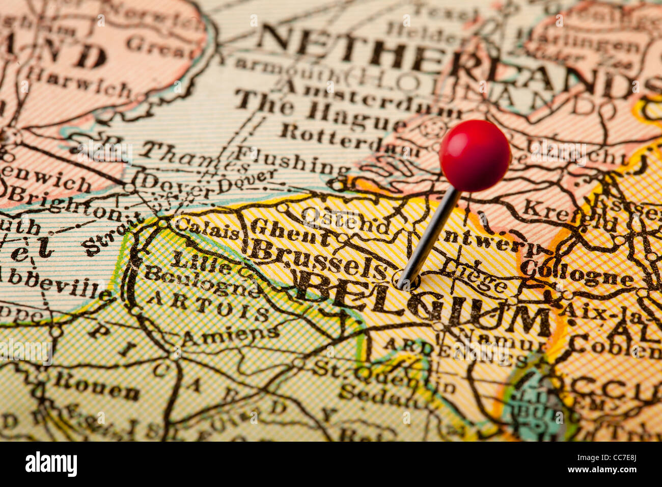 belgium and brussels european union center on vintage 1920s map with a red pushpin