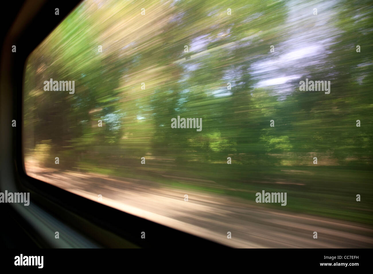 green trees - a blurred window view from a train in motion Stock Photo