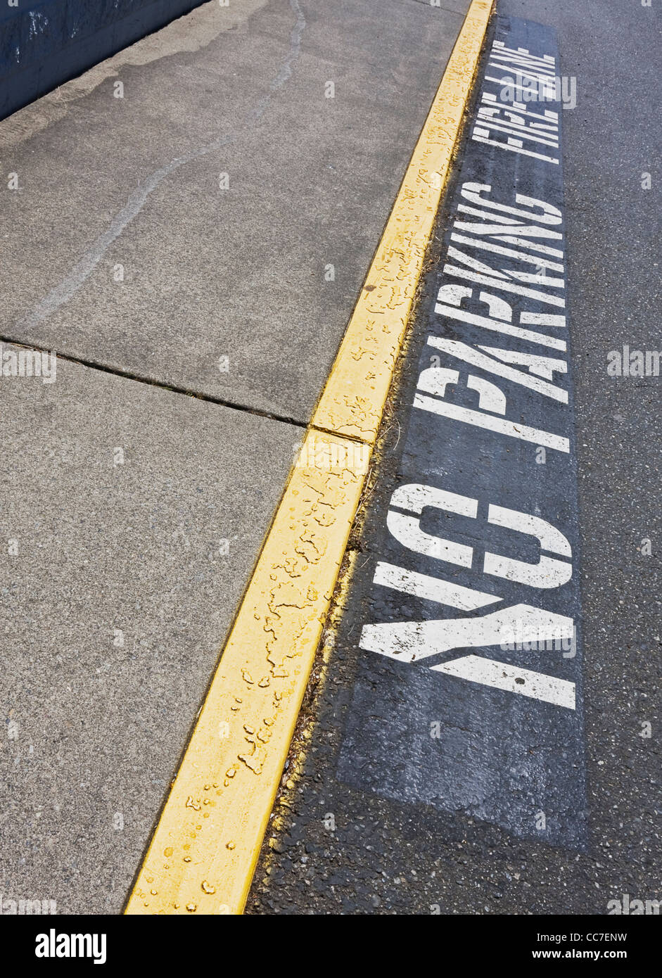 no parking fire lane painted next to curb in shopping center parking lot Stock Photo