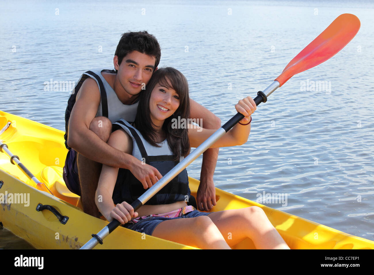 young man and woman doing canoe on a lake Stock Photo - Alamy