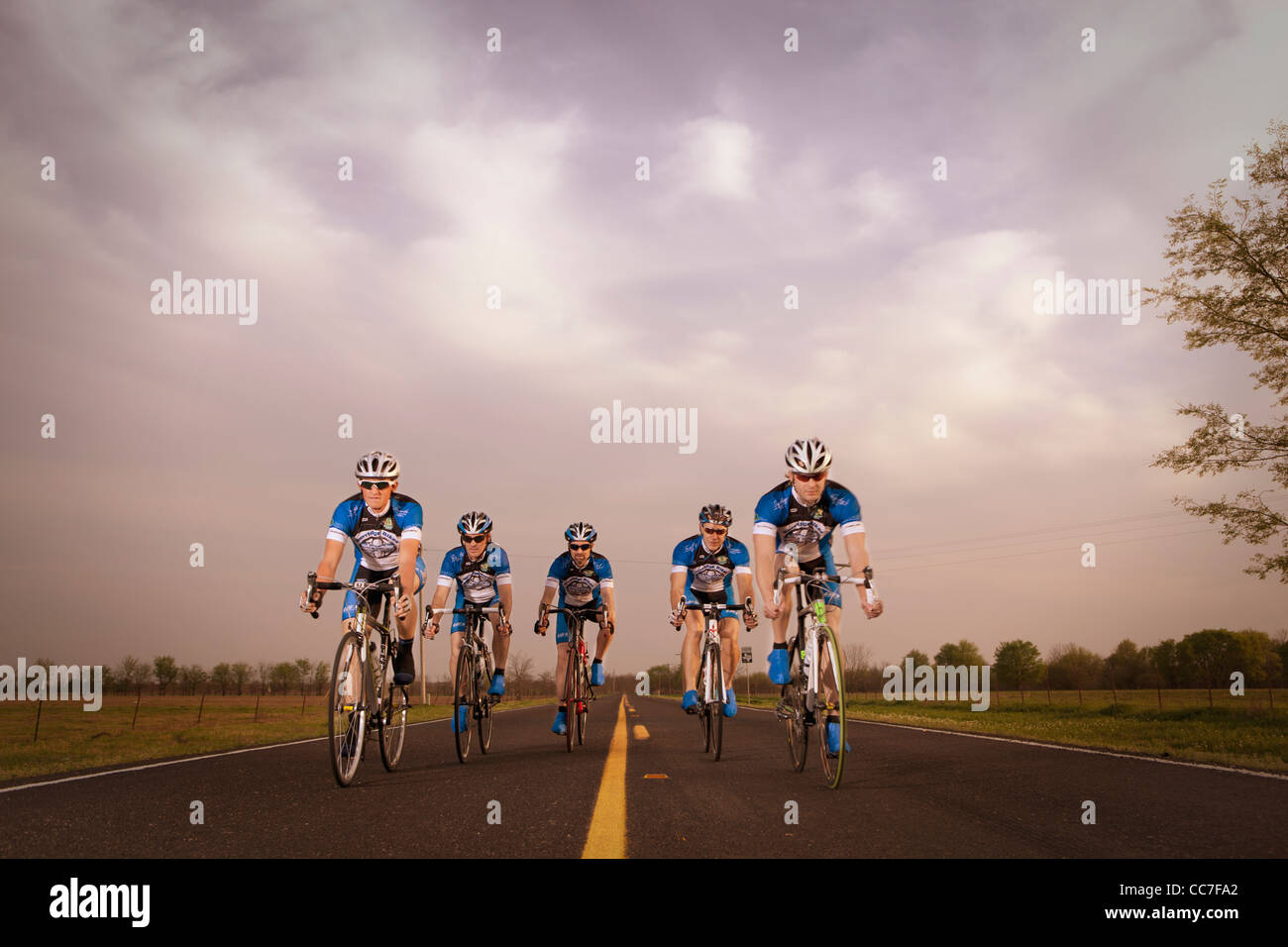 Competitive bicyclists racing on remote rode Stock Photo
