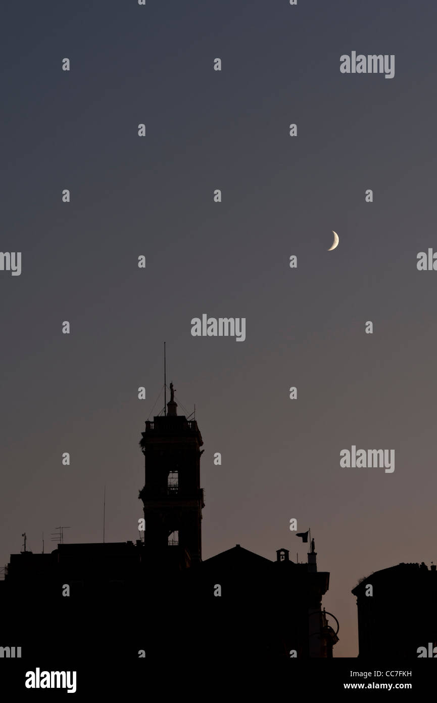 Moon over the Rome, Italy skyline. Stock Photo