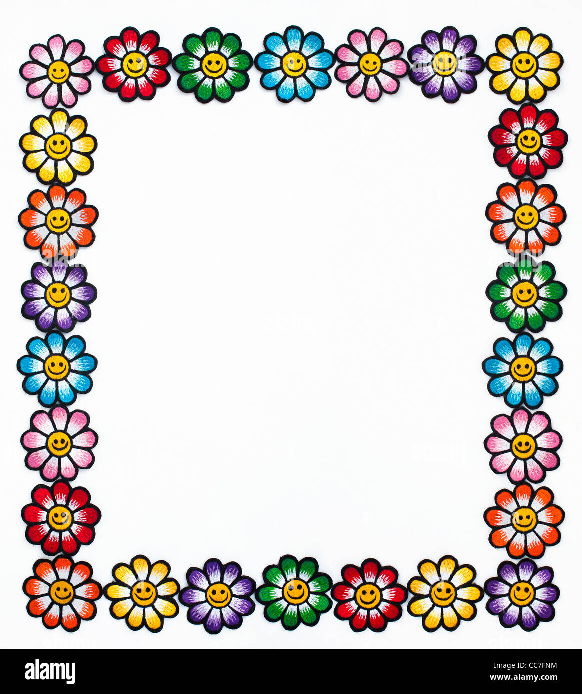 Embroidery iron on patches of Multicoloured smiley face flowers in a frame on a white background Stock Photo