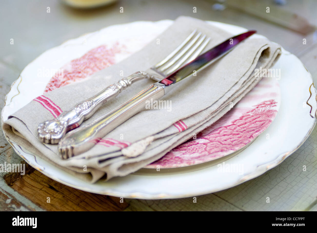 Silverware and napkin on plate Stock Photo