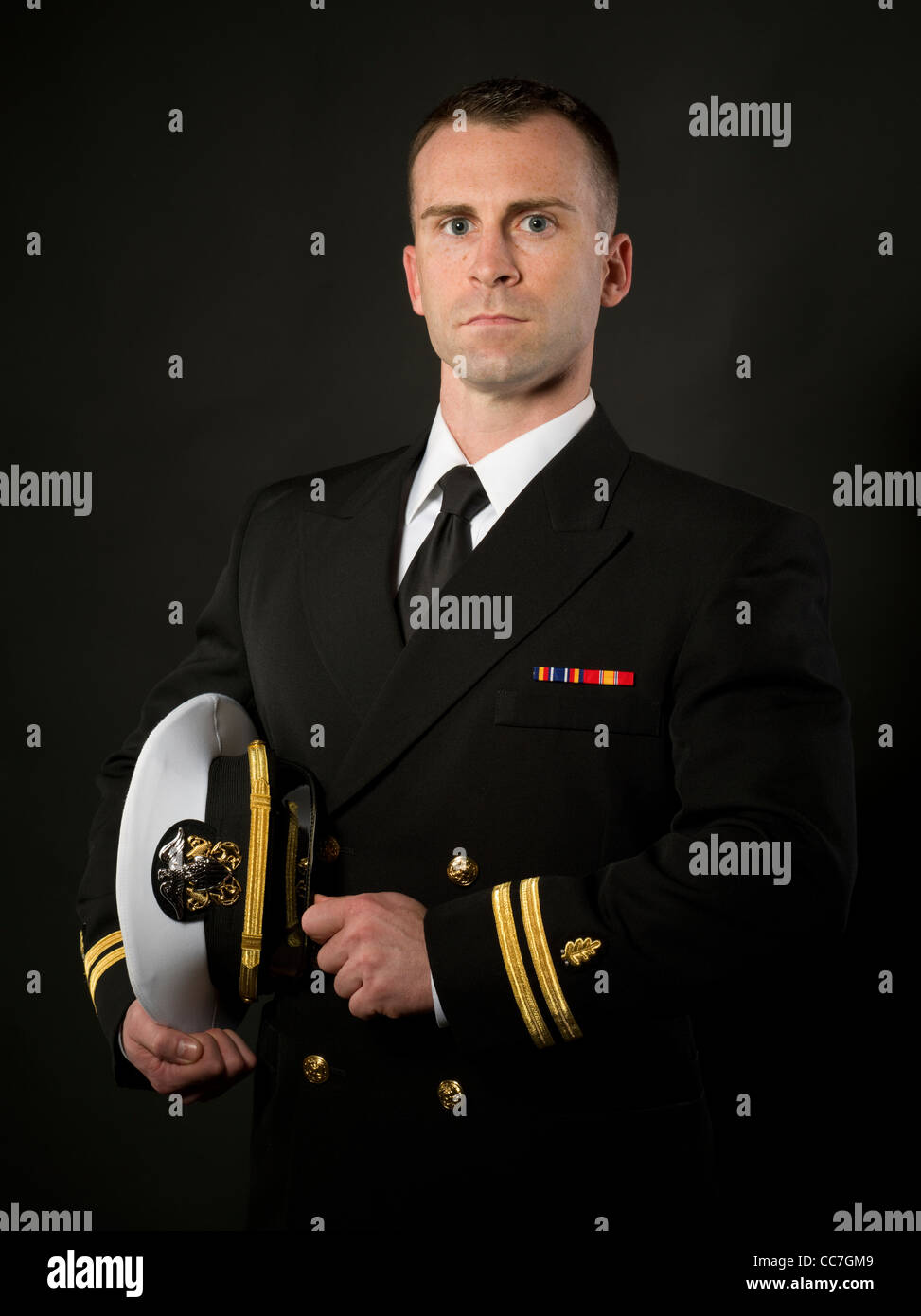 United States Navy Officer in Service Dress Blues Uniform with Combination Cover ( hat ) Stock Photo