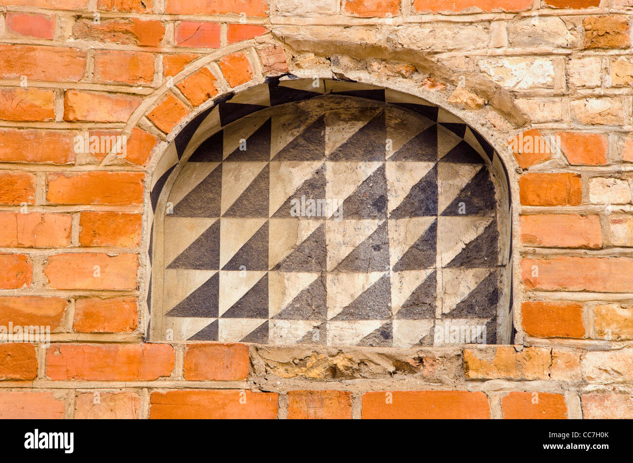 Abandoned building of red brick wall and arches background. Stock Photo