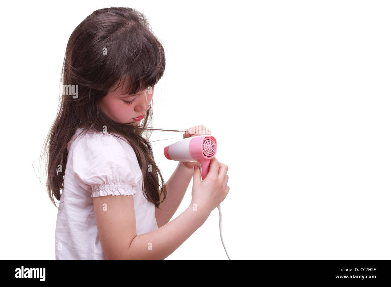 Pretty girl drying her hair hairdryer isolated on white Stock Photo - Alamy