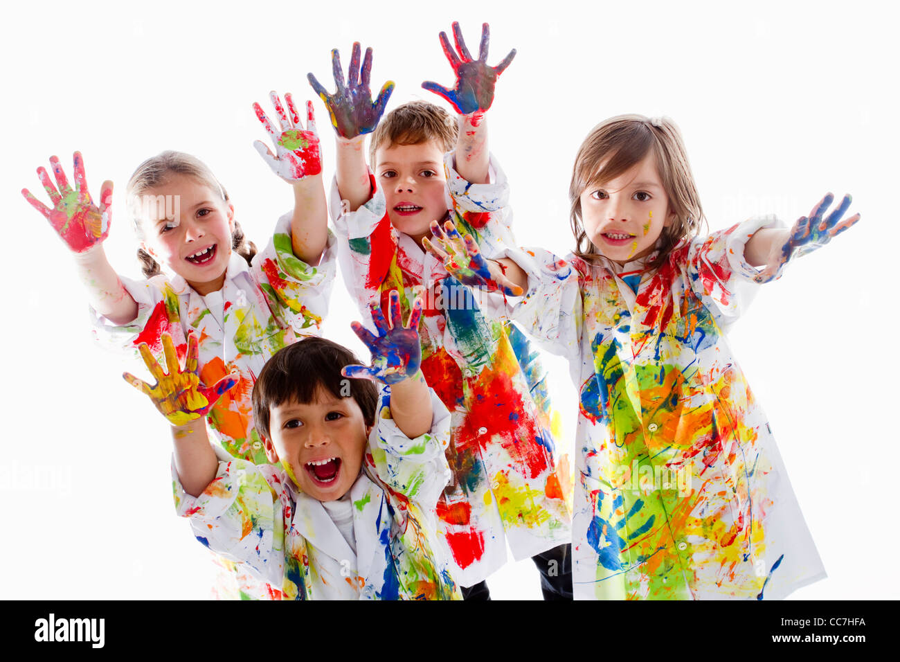 Messy Hispanic children finger painting Stock Photo - Alamy