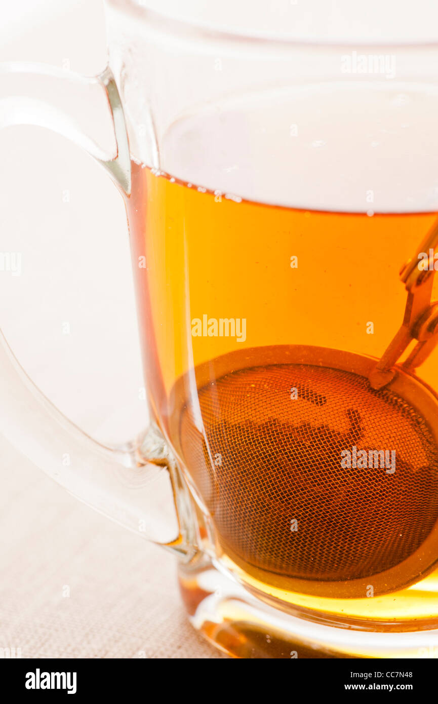 Glass cup with tea and tea strainer Stock Photo Alamy