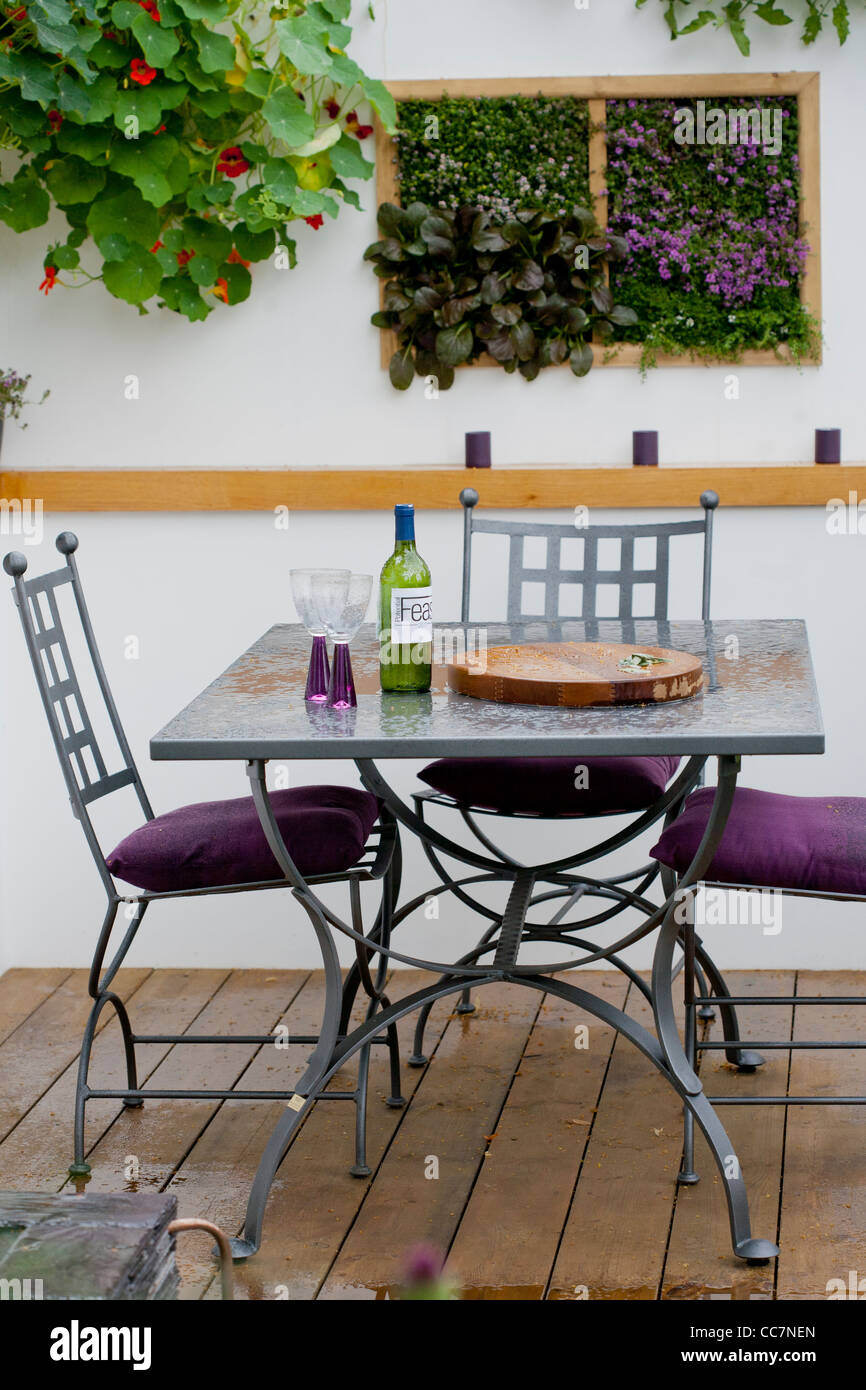 Dining area on decking in contemporary garden. Stock Photo