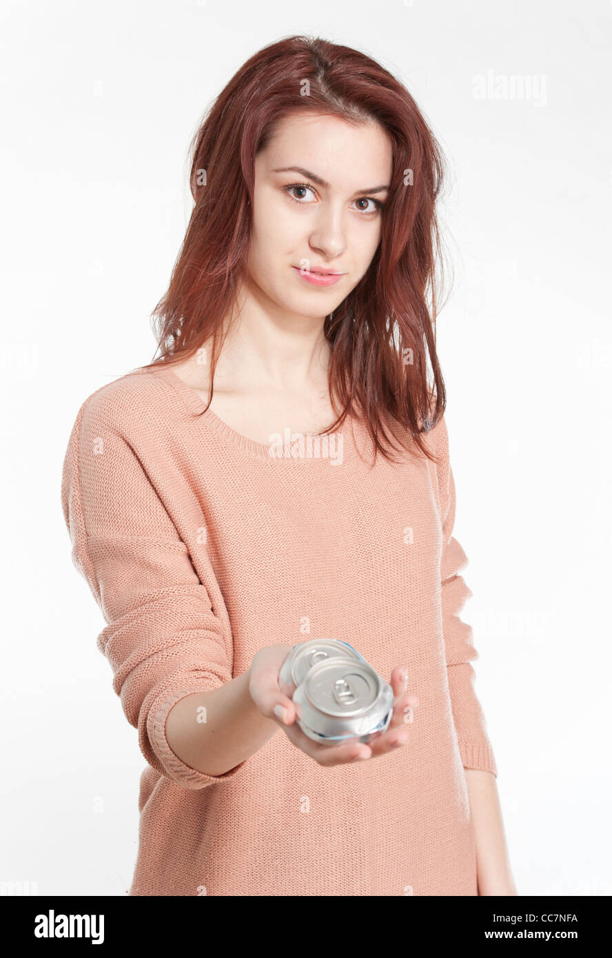 Young woman holding crushed drink cans Stock Photo