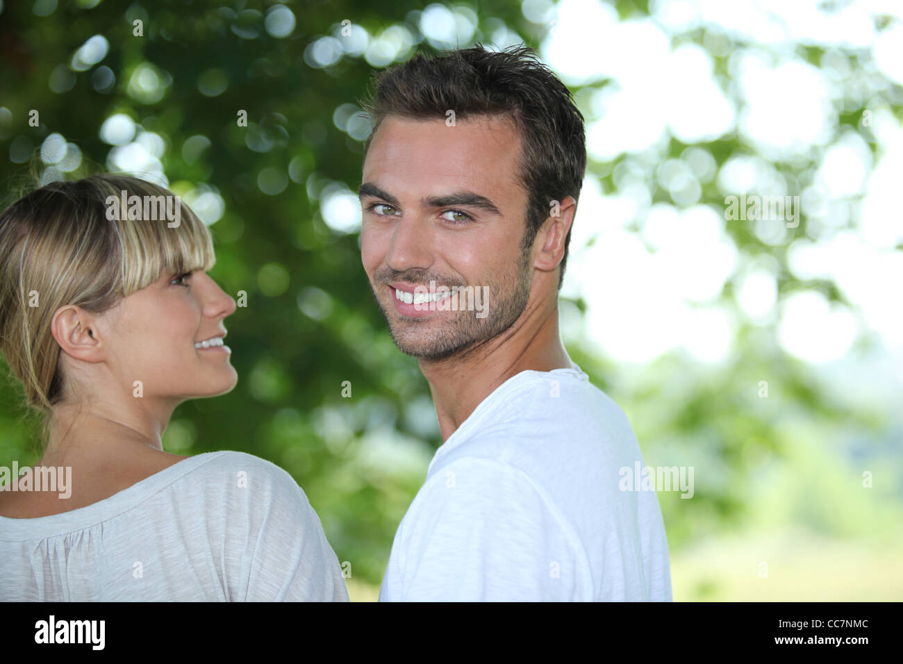 Young couple in a park Stock Photo - Alamy