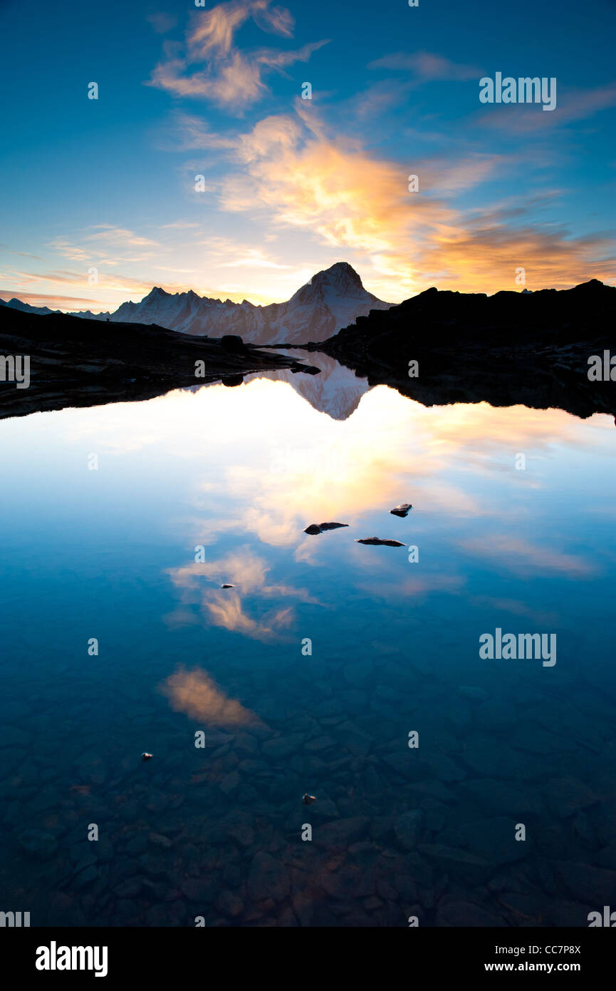 Bietschorn mountain peak at sunrise reflecting in small lake, Loetschenpass, Wallis, Switzerland Stock Photo