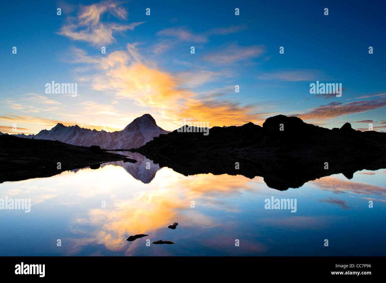 Bietschorn mountain peak at sunrise reflecting in small lake, Loetschenpass, Wallis, Switzerland Stock Photo