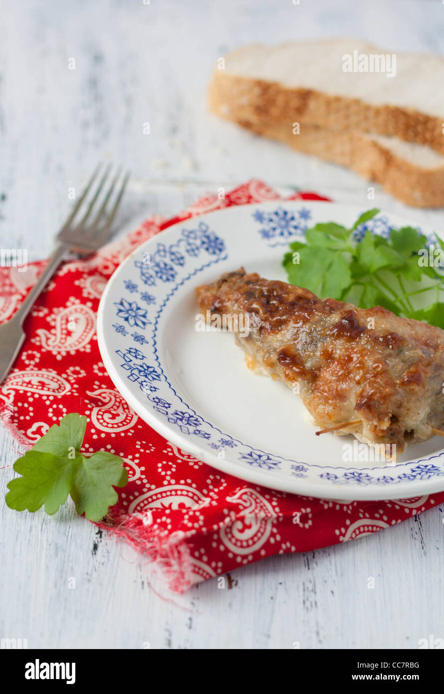 Stuffed roasted drumstick with parsley on a plate Stock Photo