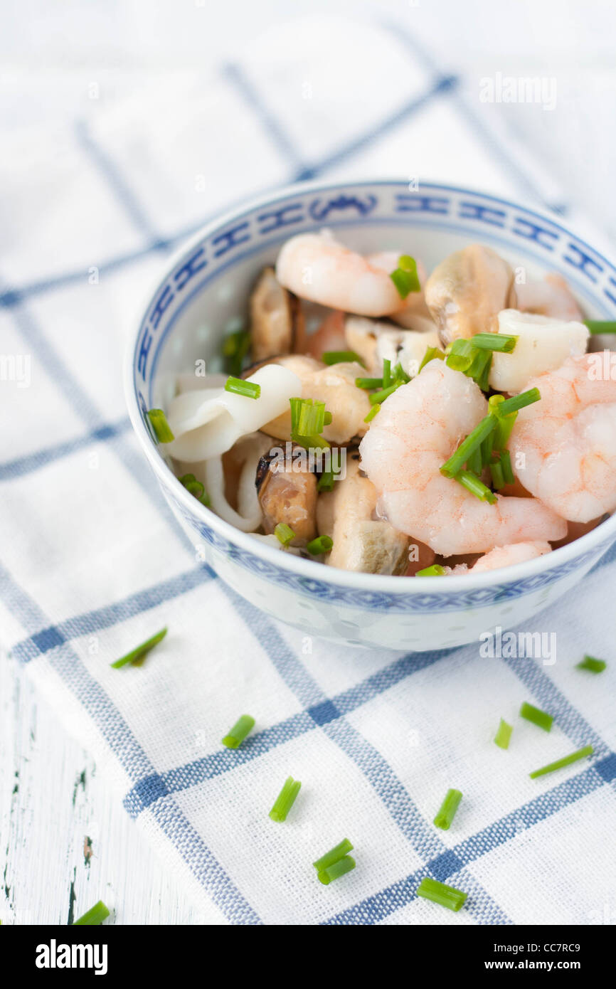 Prawns, squid, mussels in a Chinese blue bowl Stock Photo