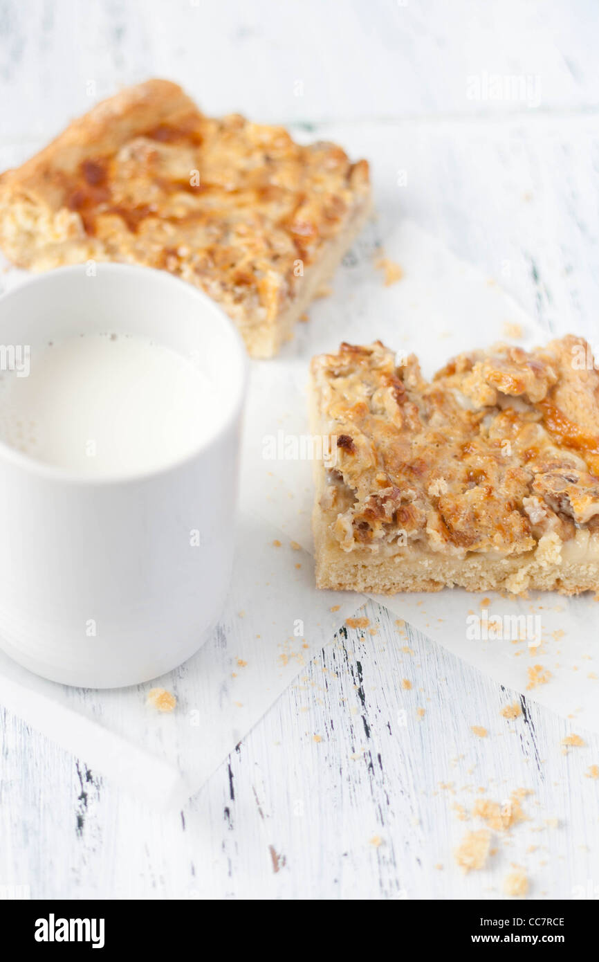 Walnut cookies with milk on a distressed table Stock Photo