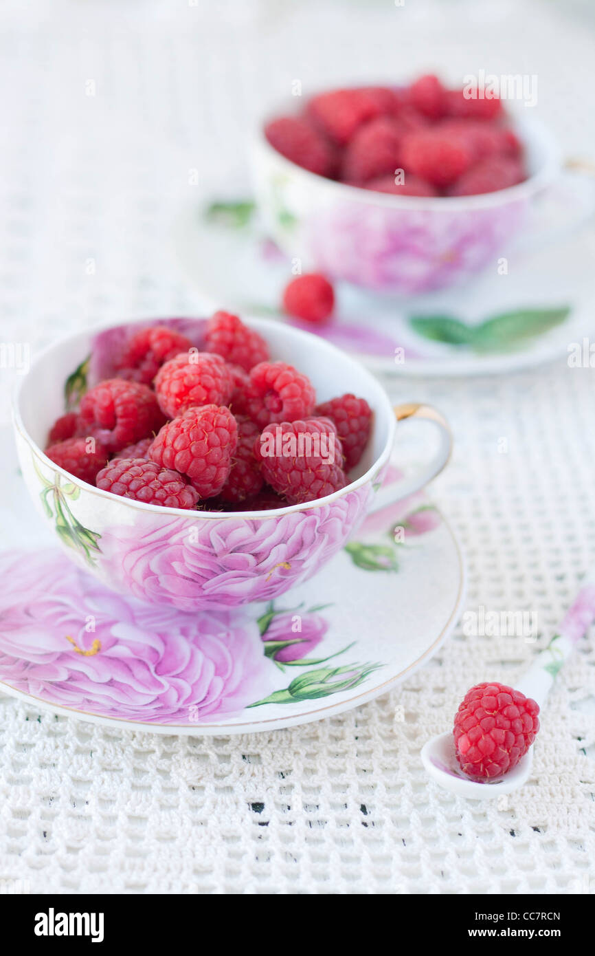 Raspberries in cups on a crochet tablecloth Stock Photo