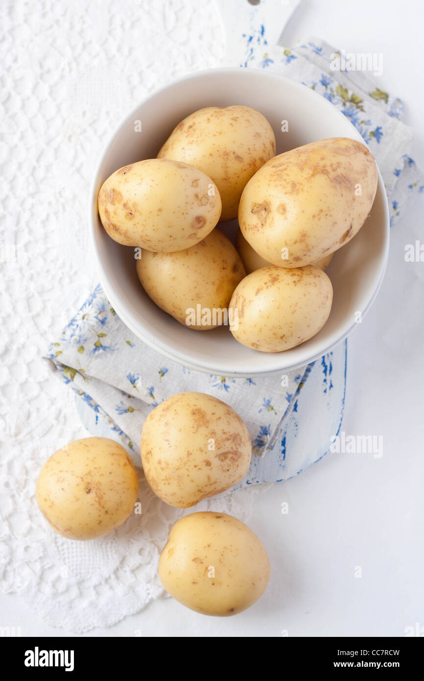 Potatoes in a white bowl from above Stock Photo