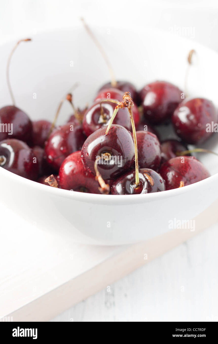 Closeup of ripe cherries in a white bowl Stock Photo