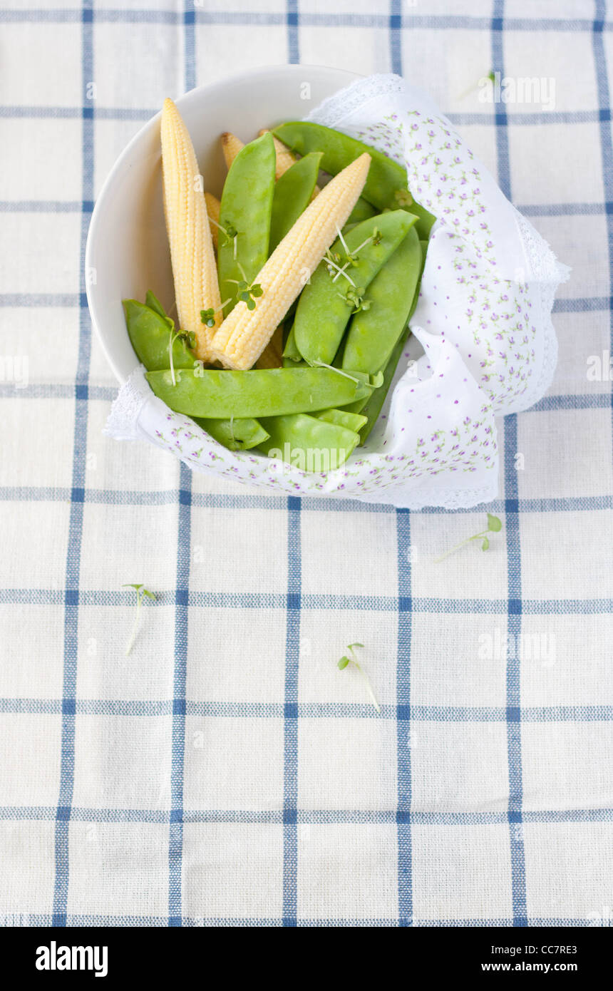 Baby corns and sweet peas with cress in a bowl Stock Photo
