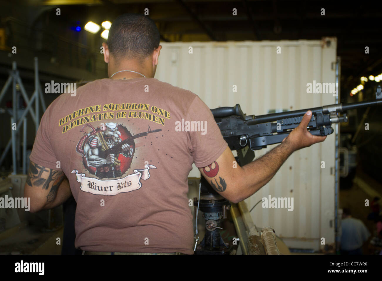 A US Marine aboard the Iwo Jima demonstrates a machine gun during Fleet Week 2011 in New York City Stock Photo