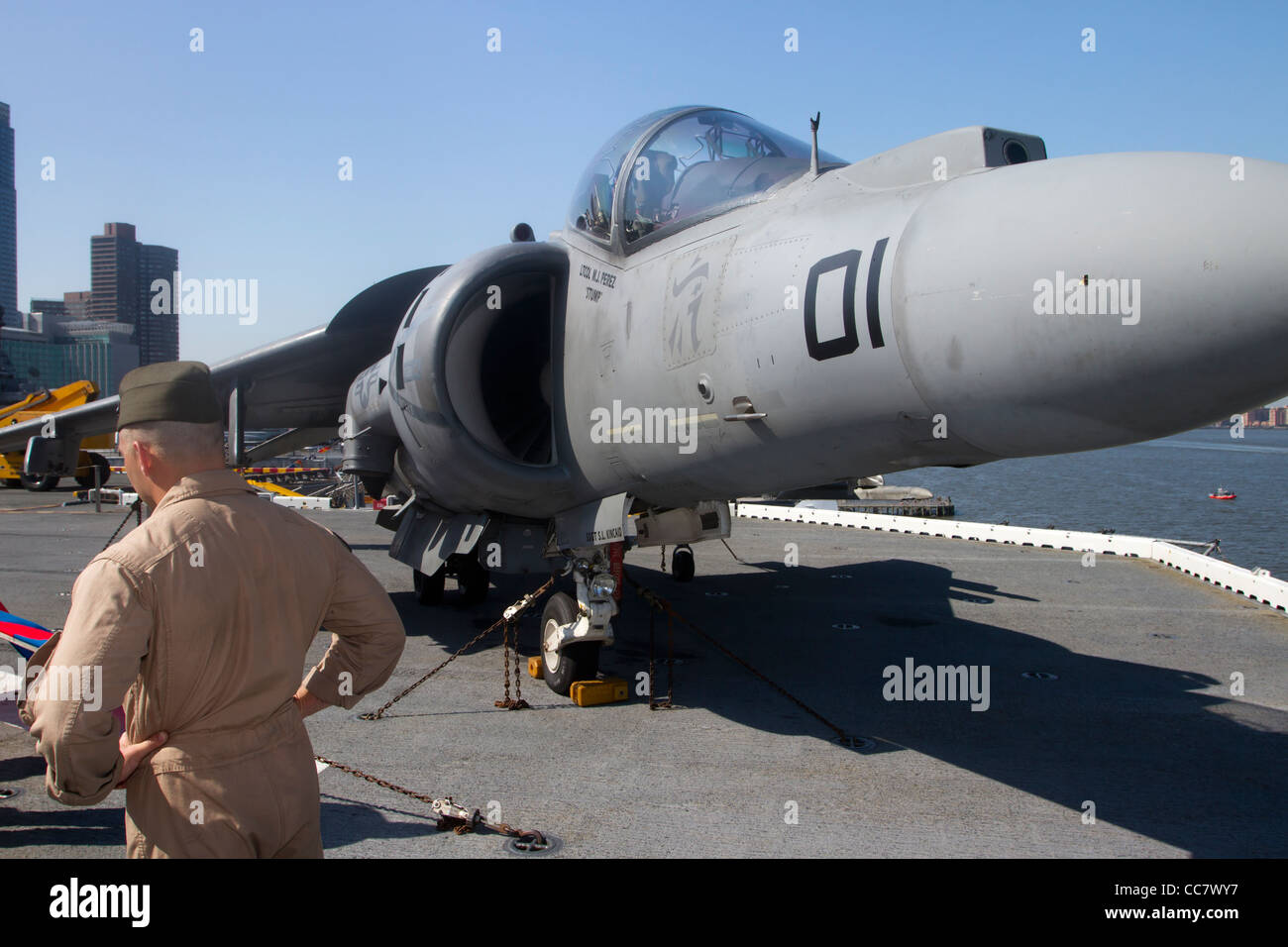A Marine pilot standing next to his Harrier on the flight deck of the USS Iwo Jima during Fleet Week 2011 in New York City Stock Photo