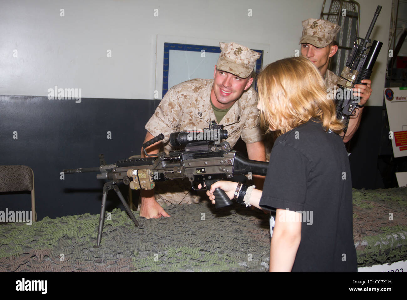 Marines demonstrate an assault rifle to a young boy on board the USS Iwo Jima during Fleet Week 2011 in New York City Stock Photo