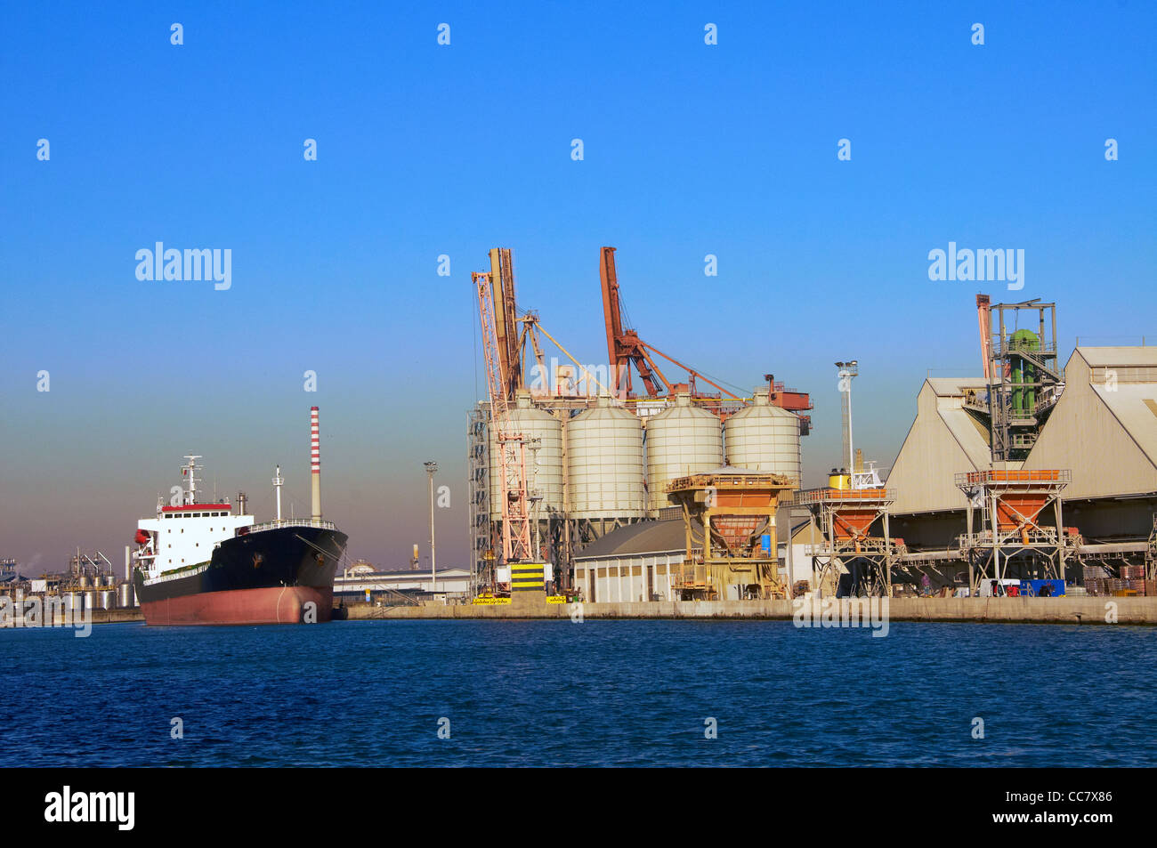 bulk business cargo carrier commerce commercial container crane delivery dock dusk evening