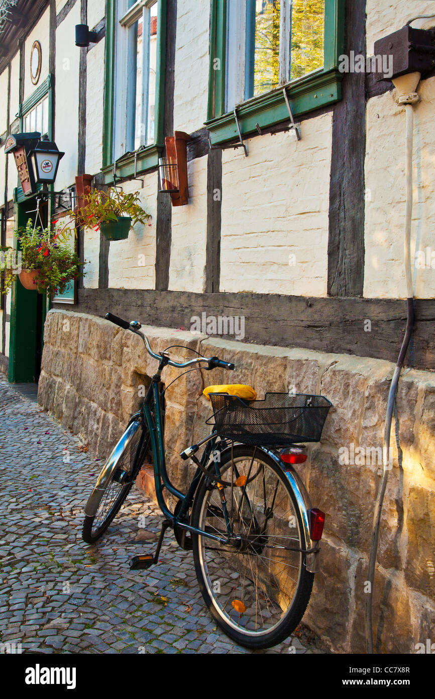 Bicycle in a cobbled street of half-timbered medieval houses in the UNESCO World Heritage town of Quedlinburg, Germany. Stock Photo