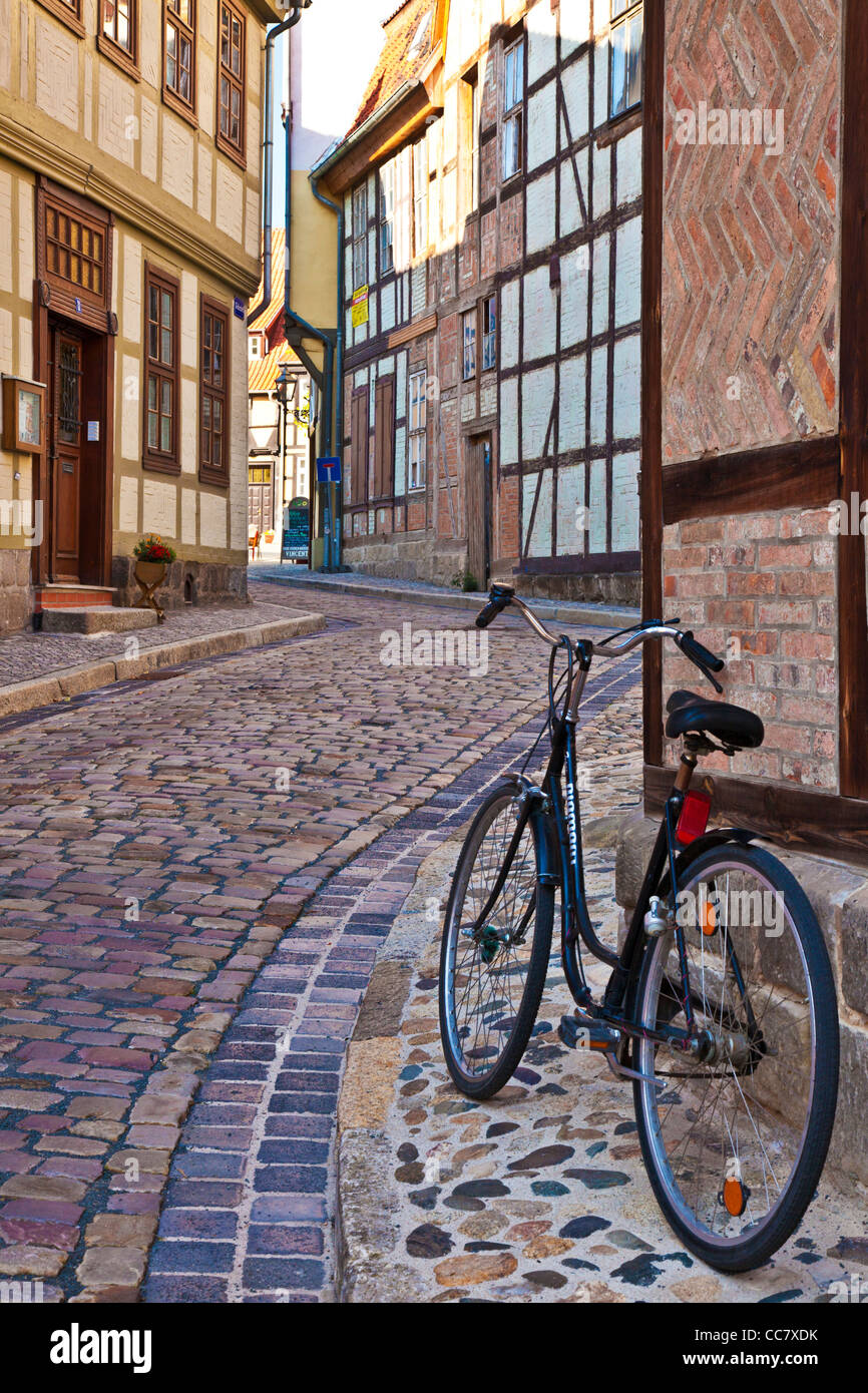 Bicycle in a cobbled street of half-timbered medieval houses in the UNESCO World Heritage town of Quedlinburg, Germany. Stock Photo