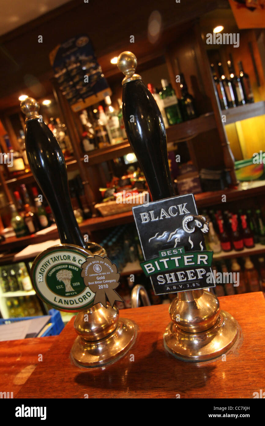 Real Ale hand pumps in a traditional Yorkshire dales country pub Stock Photo