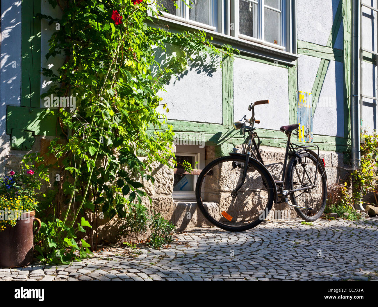 Bicycle in a cobbled street of half-timbered medieval houses in the UNESCO World Heritage town of Quedlinburg, Germany. Stock Photo