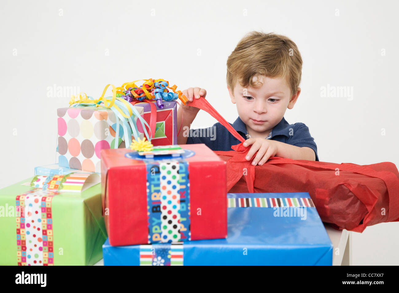 Young Boy opening Birthday Presents Stock Photo