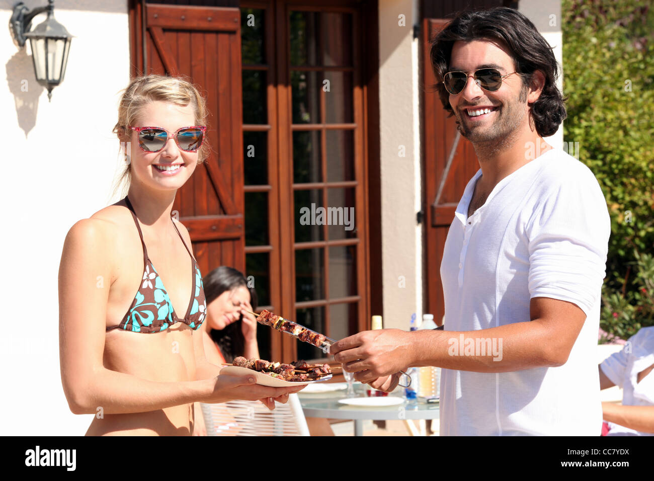 Friends enjoying a barbecue together Stock Photo