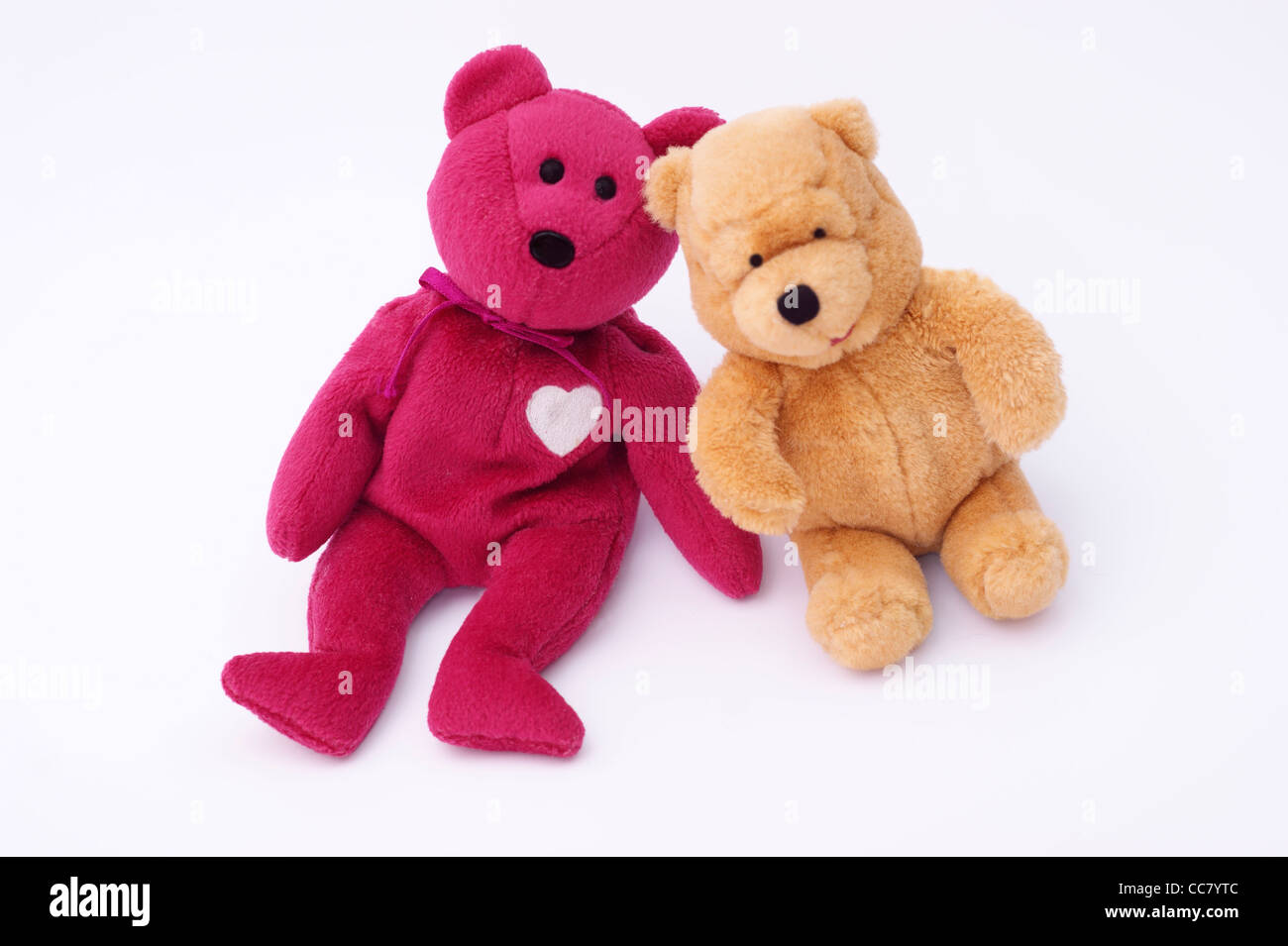 2 friendly cuddly toy teddy bears isolated on a white background Stock Photo