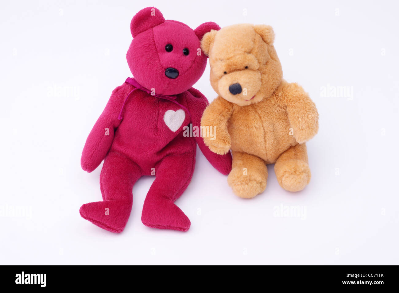 2 friendly cuddly toy teddy bears isolated on a white background Stock Photo