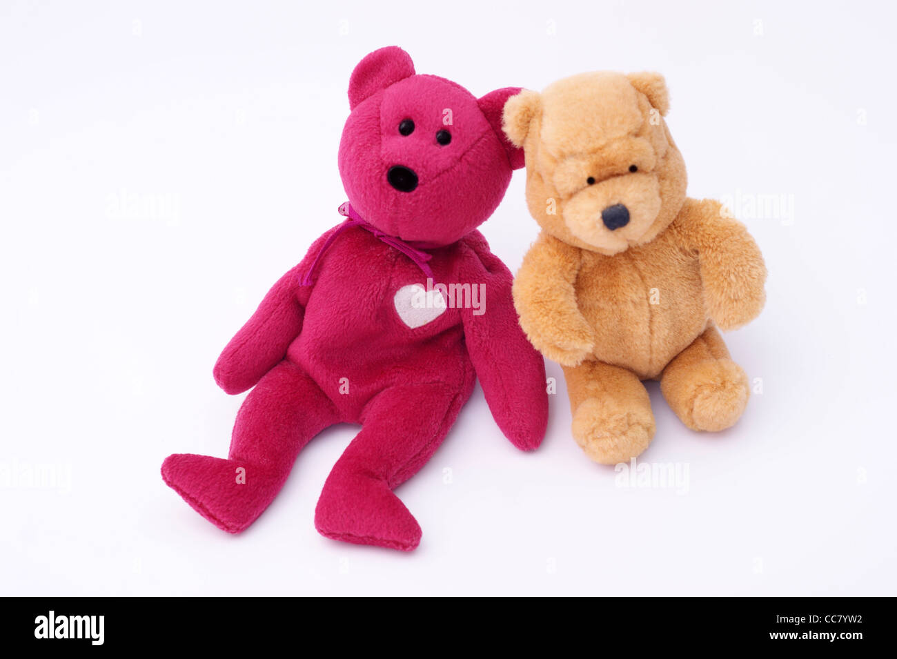 2 friendly cuddly toy teddy bears isolated on a white background Stock Photo