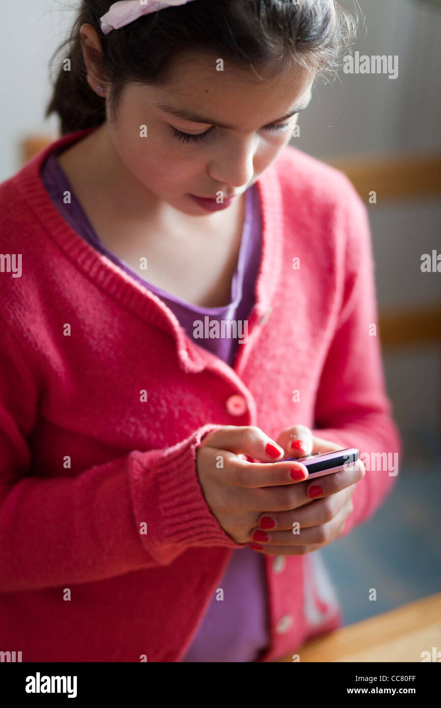 Girl texting on a mobile phone Stock Photo