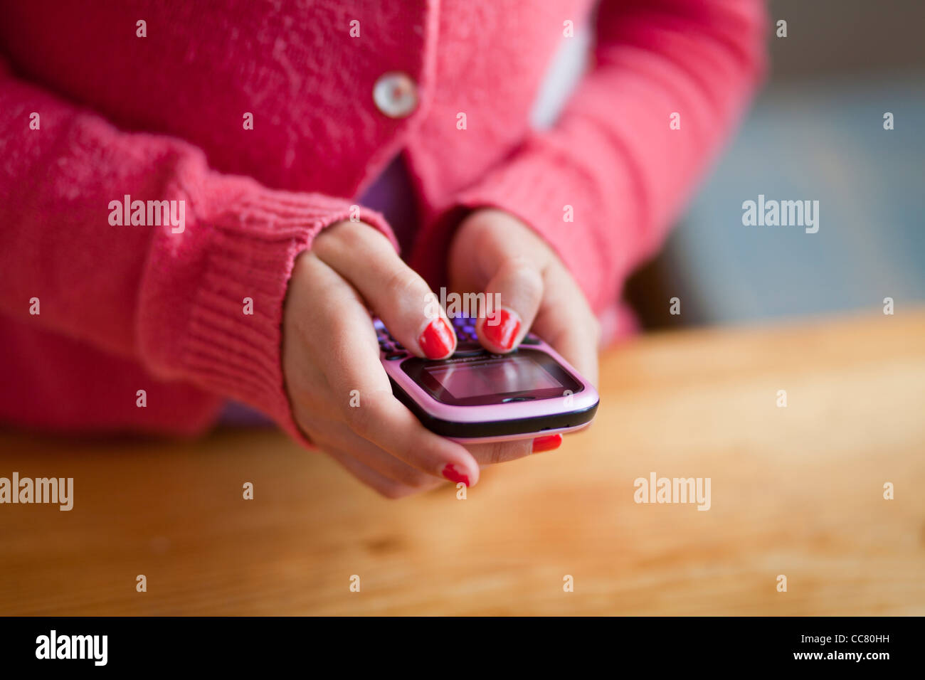 Girl texting on a mobile phone Stock Photo