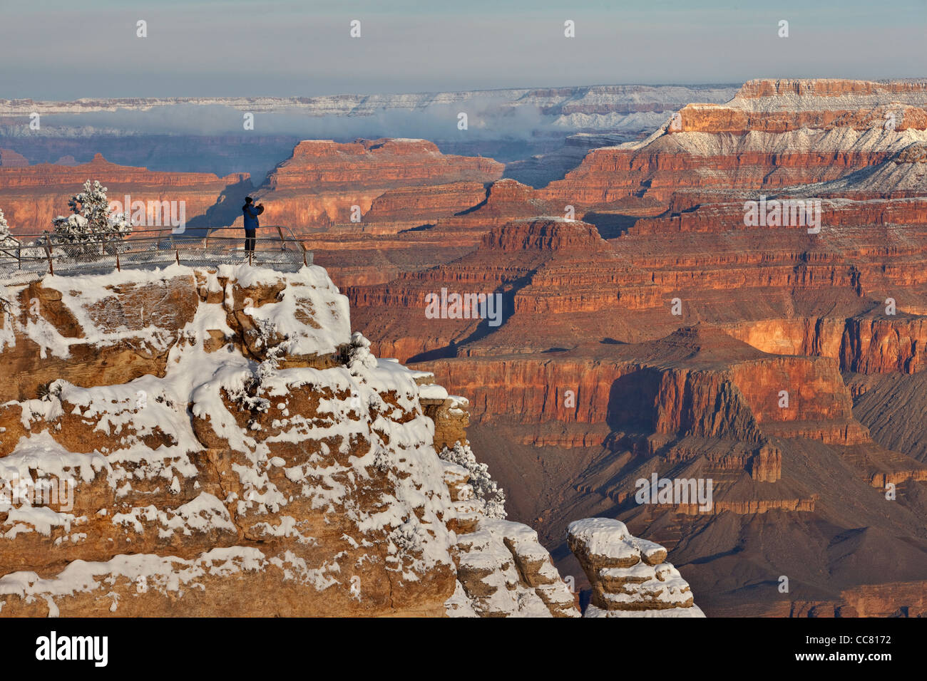 Photographer on canyon rim, winter view at Mather Point, South Rim of Grand Canyon National Park, Arizona, USA, Stock Photo